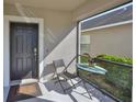 Cozy screened porch with table and chairs, near the front door at 1413 Tahoe Springs Ct, Ruskin, FL 33570