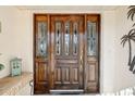 Elegant wooden front door with glass panels and sidelights at 1928 E View Dr, Sun City Center, FL 33573
