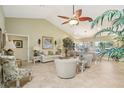 Bright living room with vaulted ceiling, neutral color palette and comfortable seating at 1928 E View Dr, Sun City Center, FL 33573