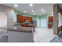 Spacious kitchen featuring wood cabinets and granite countertops at 2044 Heartland Cir, Valrico, FL 33594