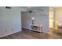 Bright living room with light walls, wood-look floors, and tasteful decor at 209 Ne Lincoln N Cir # 109, St Petersburg, FL 33702