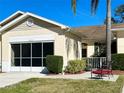 Front view of villa showing carport, walkway, and landscaping at 2116 Nantucket Dr # 19, Sun City Center, FL 33573