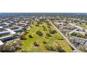 Aerial view of the community with a golf course, surrounding neighborhood, and mature trees at 2468 Florentine Way # 52, Clearwater, FL 33763