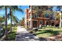 Building exterior showcasing a pathway, landscaping, and waterfront views at 2757 Via Cipriani # 1114A, Clearwater, FL 33764