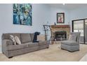 Living room features a fireplace, sofa, and armchair at 3985 Mermoor Dr, Palm Harbor, FL 34685