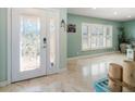 Bright and airy entryway with a unique glass front door and tile flooring at 3998 South Cir, Largo, FL 33774