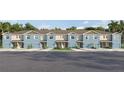 Blue townhouses with attached garages and small front yards at 4459 Rachel Falls Dr, Tampa, FL 33610