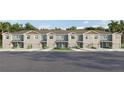 Tan townhouses with attached garages and small front yards at 4459 Rachel Falls Dr, Tampa, FL 33610