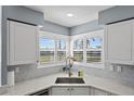 Corner sink and white cabinets in a galley kitchen at 6191 Bahia Del Mar Blvd # 201, St Petersburg, FL 33715
