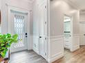 Bright entryway with white wainscoting and a glass door at 631 12Th N Ave, Safety Harbor, FL 34695