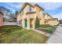 Two-story townhome with a grassy yard and walkway at 8729 Sheldon Creek Blvd, Tampa, FL 33615