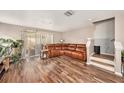 Living room with hardwood floors, a sectional sofa, and a view of the backyard at 8729 Sheldon Creek Blvd, Tampa, FL 33615
