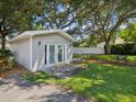 Detached studio with double doors and a patio furniture set at 1055 Philippe Pkwy, Safety Harbor, FL 34695