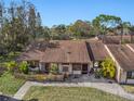 Exterior view of the property, showing the roofline and landscaping at 106 Edgewood Ct, Oldsmar, FL 34677