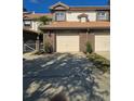 Exterior of brick townhouse with two car garage and tropical landscaping at 1294 Clays Trl # 1294, Oldsmar, FL 34677