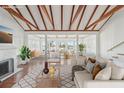 Bright and airy living room featuring vaulted ceilings, hardwood floors, and water views at 14157 N Bayshore Dr, Madeira Beach, FL 33708
