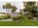 The Beach Cottage entrance, with palm trees and well-manicured lawn at 18400 Gulf Blvd # 1505, Indian Shores, FL 33785