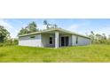Gray house with covered patio and grassy backyard at 191 Prineville St, Port Charlotte, FL 33954