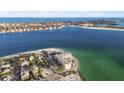 Stunning aerial view of beachfront condos in a coastal community with beautiful blue ocean at 200 1St Ave # 312, St Pete Beach, FL 33706