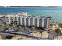 A beautiful condo building near the beach with palm trees, ample parking, and stunning ocean views at 200 1St Ave # 312, St Pete Beach, FL 33706