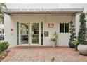 Modern building entrance with brick pavers and potted plants at 210 5Th S Ave # 307, St Petersburg, FL 33701