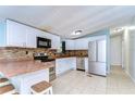 Bright kitchen with white cabinets, stainless steel appliances, and tile backsplash at 33933 Terrace Blvd, Wesley Chapel, FL 33543