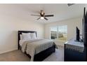 Bedroom with a double bed, dresser, and ceiling fan at 5462 Logan Cave Ave, Wimauma, FL 33598