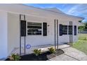 Inviting front porch with black accents and well-maintained landscaping at 5836 8Th St, Zephyrhills, FL 33542