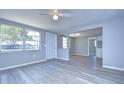 Open concept living area featuring light gray walls and vinyl plank flooring at 5836 8Th St, Zephyrhills, FL 33542