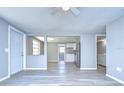 Bright and airy living room with light gray walls and wood-look flooring at 5836 8Th St, Zephyrhills, FL 33542