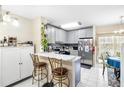 Modern kitchen with stainless steel appliances and breakfast bar at 6333 Osprey Lake Cir, Riverview, FL 33578