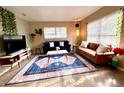 Bright living room featuring stylish sofas and a large TV at 6811 S Hesperides St, Tampa, FL 33616