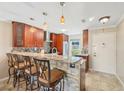 Modern kitchen with granite countertops, updated cabinetry, and breakfast bar at 7200 Ulmerton Rd # E3, Largo, FL 33771