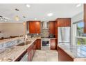 Modern kitchen with stainless steel appliances and ample cabinet space at 7200 Ulmerton Rd # E3, Largo, FL 33771