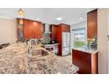 Granite countertops and stainless steel appliances in this updated kitchen at 7200 Ulmerton Rd # E3, Largo, FL 33771