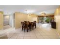 Bright dining room with table and chairs, access to balcony at 810 S Village N Dr # 201, St Petersburg, FL 33716