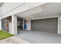 Gray house with a blue door, screened porch, and a gray garage at 1866 Michigan Ne Ave, St Petersburg, FL 33703