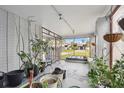 Screened porch with potted plants and a view of the backyard at 1866 Michigan Ne Ave, St Petersburg, FL 33703