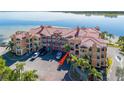 Aerial view of waterfront condo building with parking and palm trees at 2773 Via Cipriani # 1321B, Clearwater, FL 33764