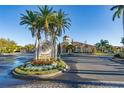 Grand Bellagio community entrance with a stone sign and lush landscaping at 2773 Via Cipriani # 1321B, Clearwater, FL 33764