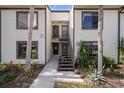 Condo building entry with stairs leading to the unit's entrance at 314 Moorings Cove Dr, Tarpon Springs, FL 34689