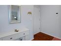 Bright condo foyer with white console table and mirror at 314 Moorings Cove Dr, Tarpon Springs, FL 34689