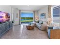 Spacious living room with a view of a lake from sliding glass doors at 4061 Westwood Fields Loop, Plant City, FL 33565