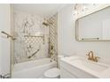 Elegant bathroom with marble walls, gold fixtures, and a large mirror at 4318 1St S Ave, St Petersburg, FL 33711
