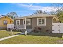 Newly renovated craftsman style home with a red door and white fence at 4318 1St S Ave, St Petersburg, FL 33711