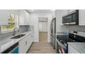 Modern kitchen with white cabinets, stainless steel appliances, and marble countertops at 4318 1St S Ave, St Petersburg, FL 33711