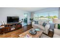 Living room with water views, comfortable seating, and a media console at 4725 Cove Cir # 211, St Petersburg, FL 33708