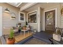 Inviting front porch with seating and potted plants at 53 Turnstone Dr, Safety Harbor, FL 34695