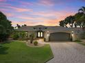 Stunning curb appeal with a landscaped yard, paver driveway, and updated facade at 725 Capri Blvd, Treasure Island, FL 33706