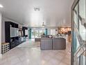 Spacious living room with large sectional sofa,water views, and modern entertainment center at 725 Capri Blvd, Treasure Island, FL 33706